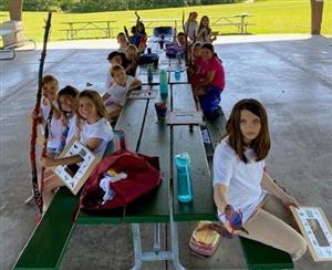 Preparing to go on a nature identification hike with the hiking sticks they made!