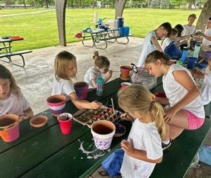 Campers decorate their own flower pots.