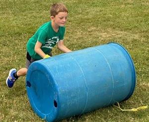 This camper trying to roll Team Yellow to victory in the barrel race.