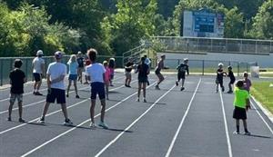 Campers hit the track for a series of 100 meter relay races!