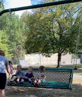 Preschoolers enjoying the new swinging bench